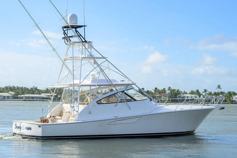  Yacht Photos Pics 2015 Viking 52 Open yacht cruising on a sunny day near coastal homes.