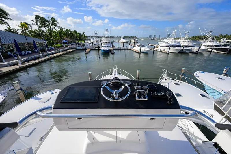  Yacht Photos Pics 2015 Viking 52 Open yacht at marina, featuring helm controls and scenic waterfront view.