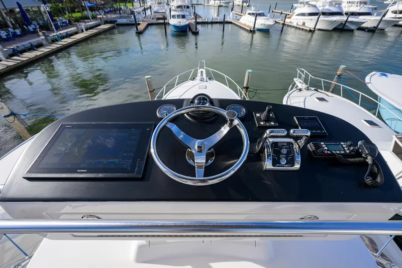  Yacht Photos Pics Helm of 2015 Viking 52 Open yacht with navigation controls and marina view.