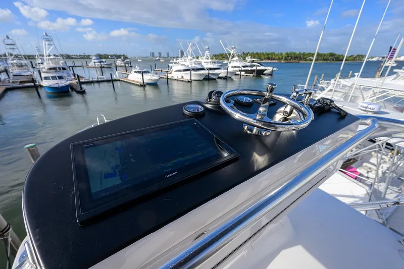  Yacht Photos Pics 2015 Viking 52 Open yacht helm with navigation display, docked at marina.