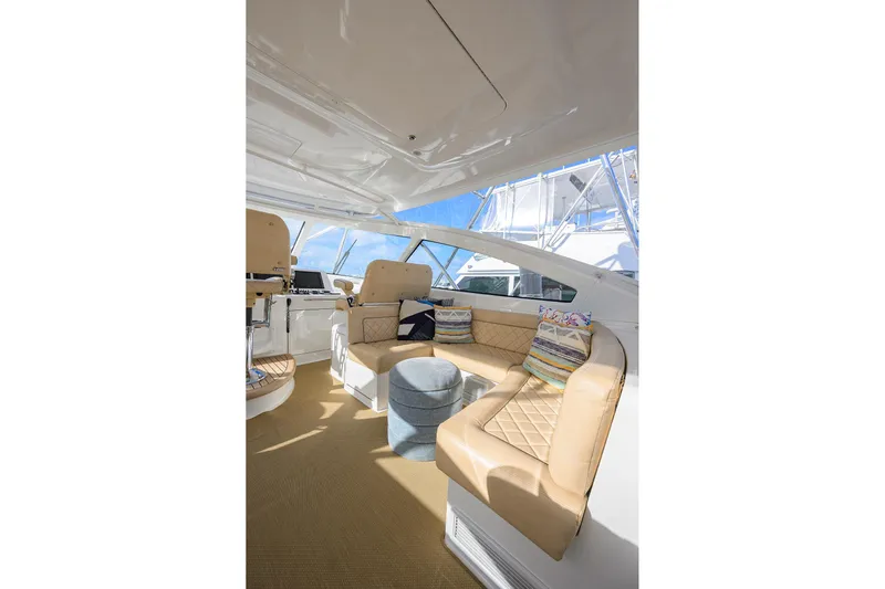 Yacht Photos Pics Luxurious interior of 2015 Viking 52 Open yacht with beige seating and helm station.
