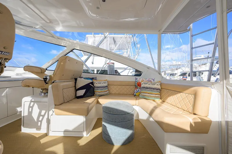  Yacht Photos Pics Luxurious interior of 2015 Viking 52 Open yacht with beige seating and colorful cushions.