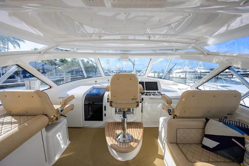  Yacht Photos Pics Interior view of 2015 Viking 52 Open yacht cockpit with luxurious seating and navigation controls.