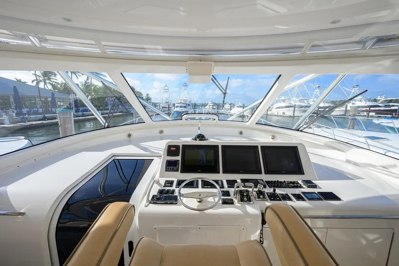  Yacht Photos Pics Interior view of 2015 Viking 52 Open yacht helm with modern controls and marina backdrop.