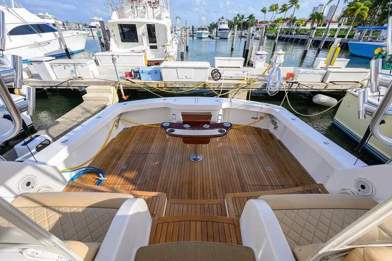  Yacht Photos Pics 2015 Viking 52 Open yacht with teak deck at marina, surrounded by boats.