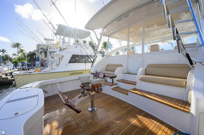  Yacht Photos Pics 2015 Viking 52 Open yacht with teak deck and fishing chair in marina.