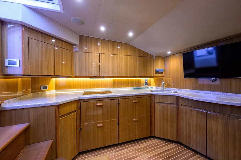  Yacht Photos Pics Luxurious interior of 2015 Viking 52 Open yacht with modern kitchen and sleek wood finish.