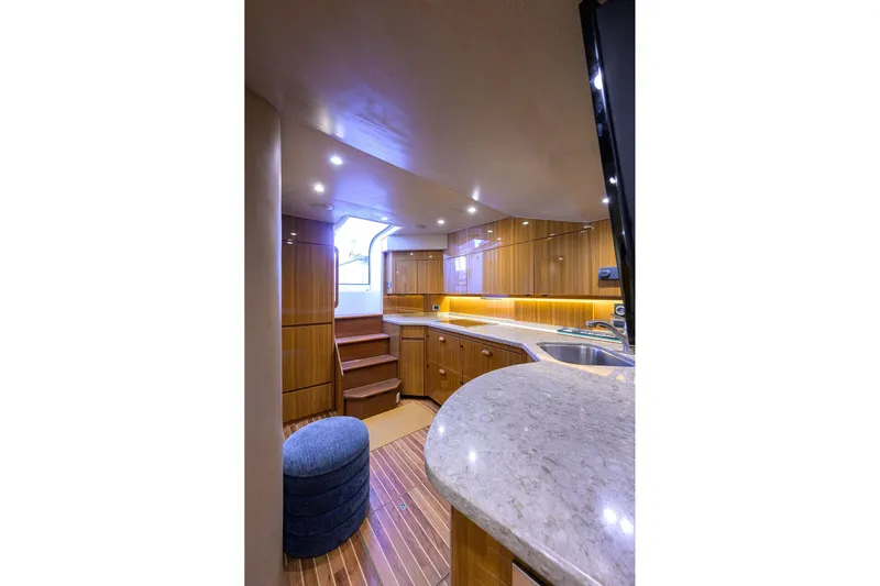  Yacht Photos Pics Luxurious interior of 2015 Viking 52 Open yacht with modern kitchen and wooden cabinetry.