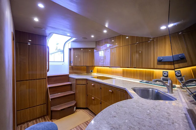  Yacht Photos Pics Luxurious interior of 2015 Viking 52 Open yacht with modern kitchen and wooden cabinetry.