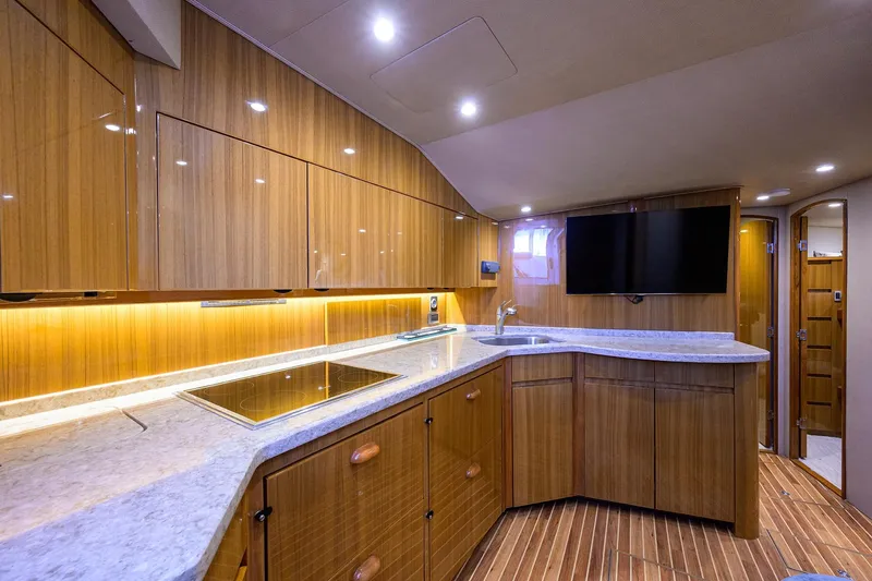  Yacht Photos Pics Luxurious interior of 2015 Viking 52 Open yacht with modern kitchen and sleek wood finishes.