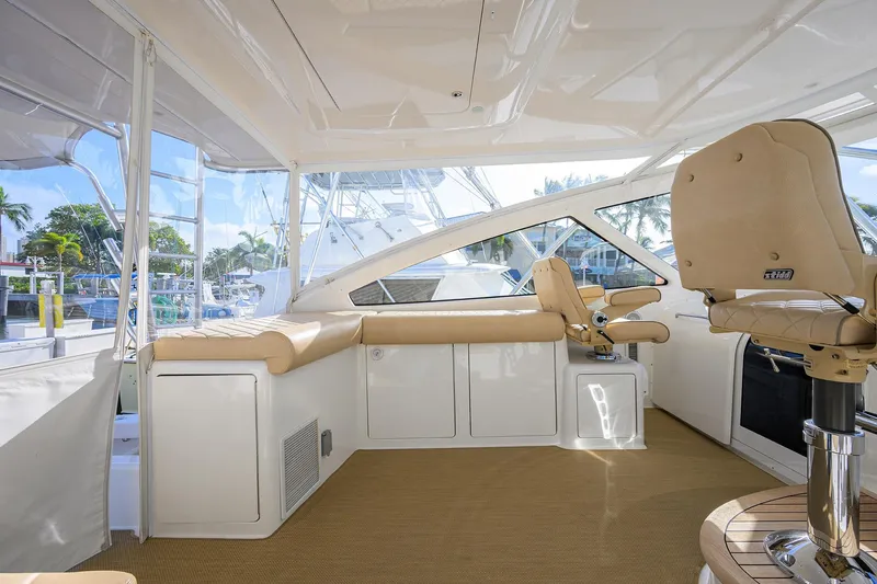  Yacht Photos Pics Luxurious interior of 2015 Viking 52 Open yacht with beige seating and helm station.