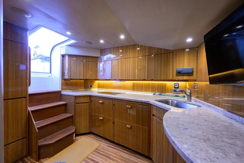  Yacht Photos Pics Luxurious interior of 2015 Viking 52 Open yacht with modern kitchen and elegant wood finishes.