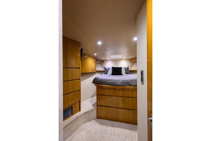  Yacht Photos Pics Luxurious cabin interior of 2015 Viking 52 Open yacht with cozy bed and wooden cabinetry.