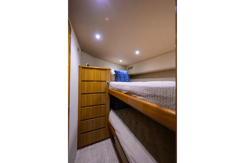  Yacht Photos Pics 2015 Viking 52 Open yacht cabin with bunk beds and wooden storage.