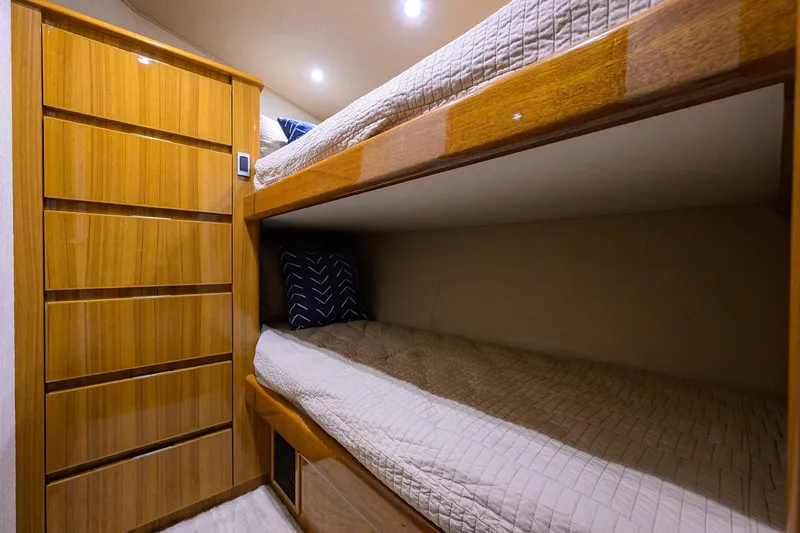  Yacht Photos Pics Bunk beds in 2015 Viking 52 Open yacht cabin with wooden cabinetry and cozy bedding.