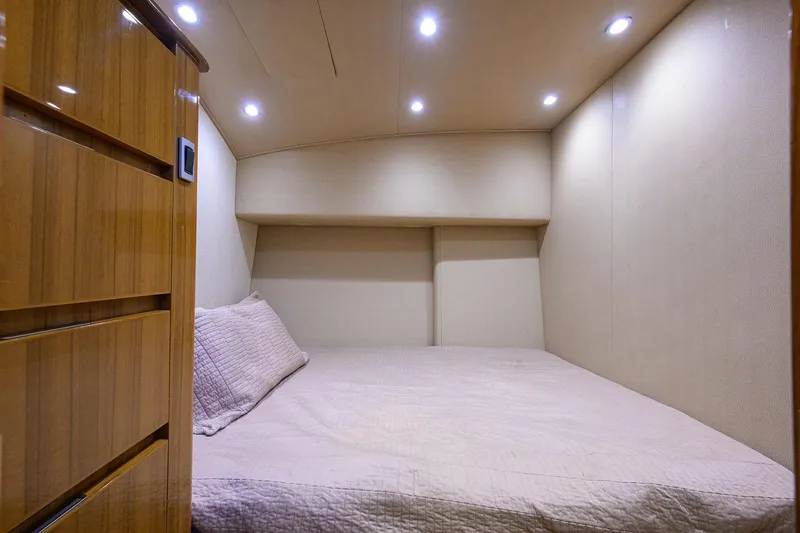  Yacht Photos Pics Cozy cabin interior of 2015 Viking 52 Open yacht with soft lighting and wooden accents.