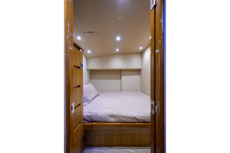  Yacht Photos Pics Interior cabin of 2015 Viking 52 Open yacht with cozy bed and wooden finish.