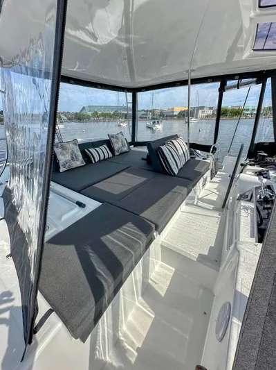 Sogno Yacht Photos Pics 2024 Lagoon 46 yacht interior with plush seating and scenic water view.