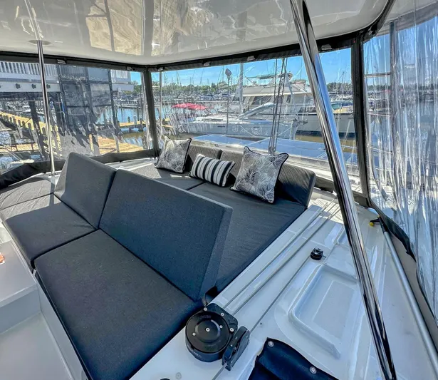 Sogno Yacht Photos Pics Luxurious interior of 2024 Lagoon 46 yacht with plush seating and marina view.