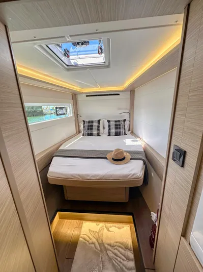 Sogno Yacht Photos Pics 2024 Lagoon 46 yacht cabin with modern design, skylight, and cozy bedding.