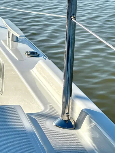 Sogno Yacht Photos Pics 2024 Lagoon 46 yacht deck detail with stainless steel railing and calm water background.