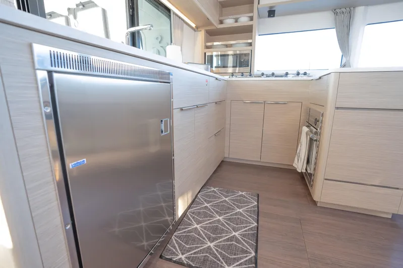 Sogno Yacht Photos Pics 2024 Lagoon 46 yacht kitchen with modern appliances and sleek cabinetry.