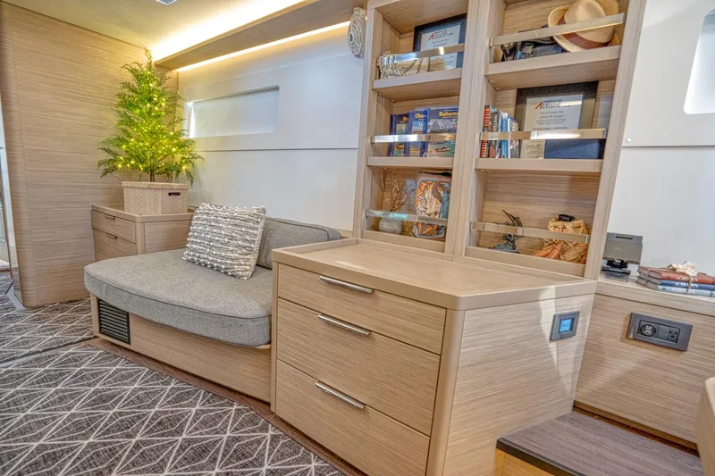 Sogno Yacht Photos Pics Modern interior of 2024 Lagoon 46 yacht with cozy seating and elegant shelving.