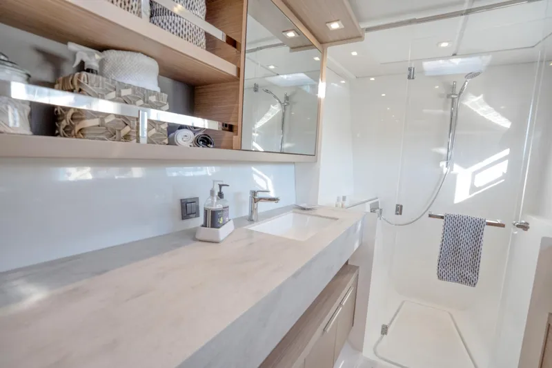 Sogno Yacht Photos Pics Luxurious bathroom in 2024 Lagoon 46 yacht with modern fixtures and spacious shower.