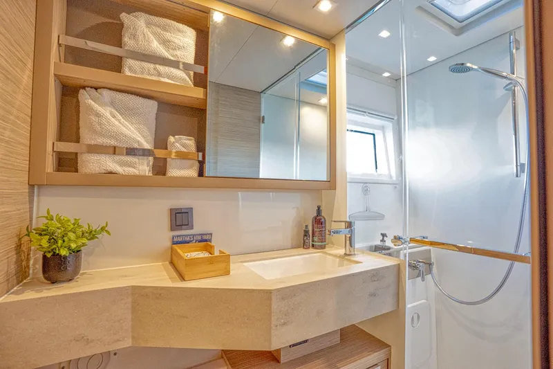 Sogno Yacht Photos Pics Luxurious bathroom in 2024 Lagoon 46 yacht with modern fixtures and elegant design.