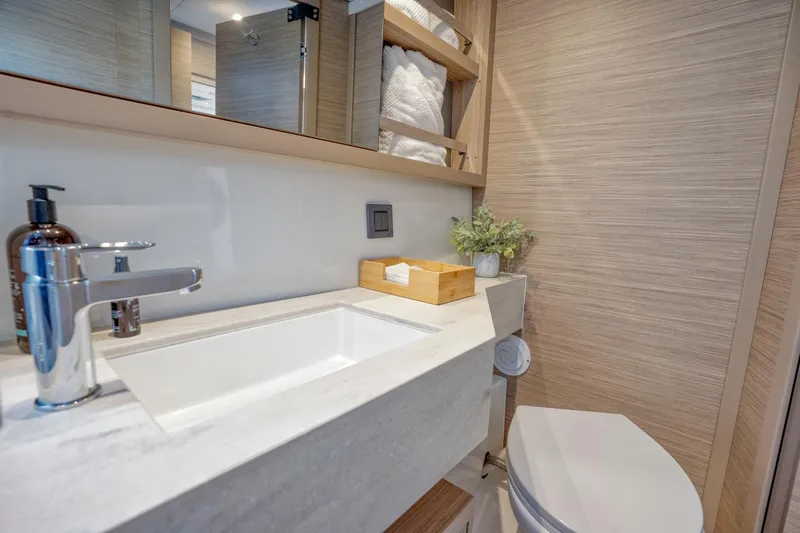 Sogno Yacht Photos Pics Modern bathroom in 2024 Lagoon 46 yacht with sleek sink and wooden accents.