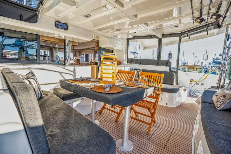 Sogno Yacht Photos Pics Luxurious 2024 Lagoon 46 yacht interior with elegant seating and dining area.