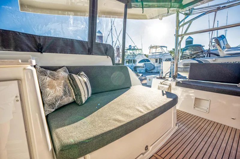 Sogno Yacht Photos Pics 2024 Lagoon 46 yacht interior with cushioned seating and marina view.