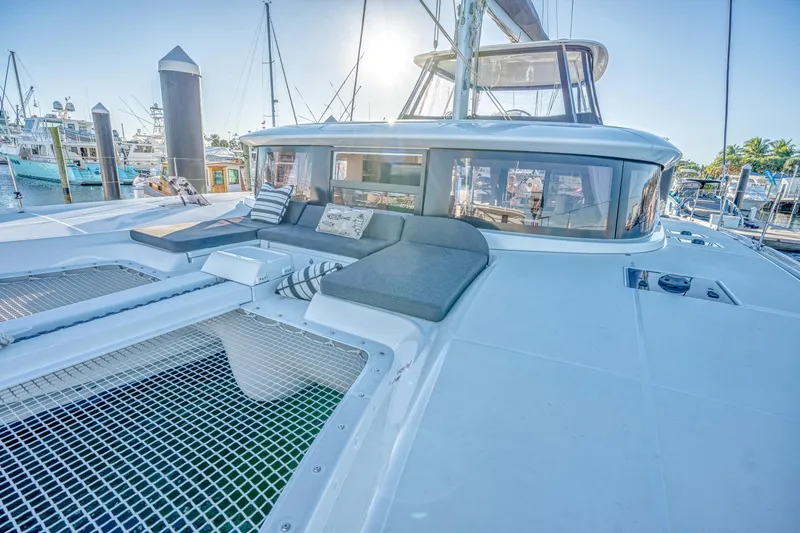 Sogno Yacht Photos Pics 2024 Lagoon 46 catamaran with spacious deck and comfortable seating in a marina setting.