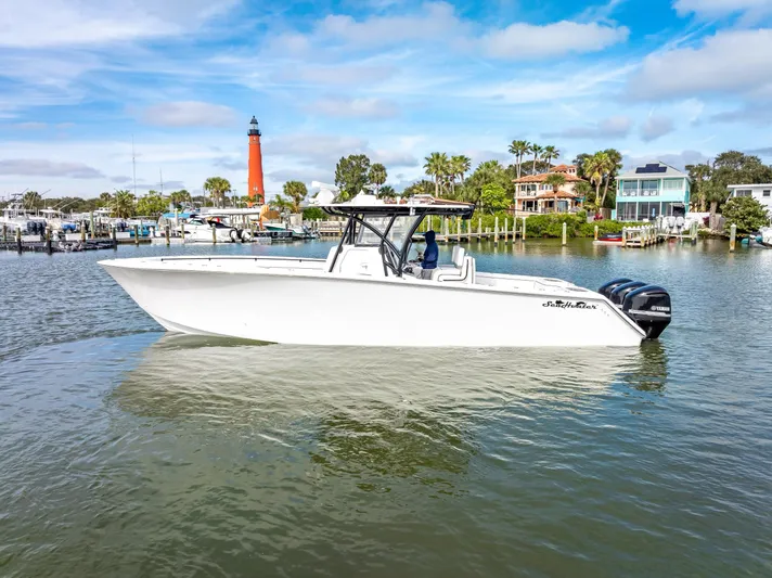  Yacht Photos Pics 2020 SeaHunter 35 Tournament boat on calm waters with lighthouse in background.