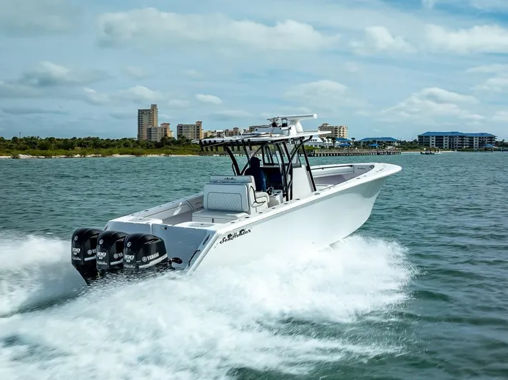  Yacht Photos Pics 2020 SeaHunter 35 Tournament boat cruising on water with triple Yamaha engines.