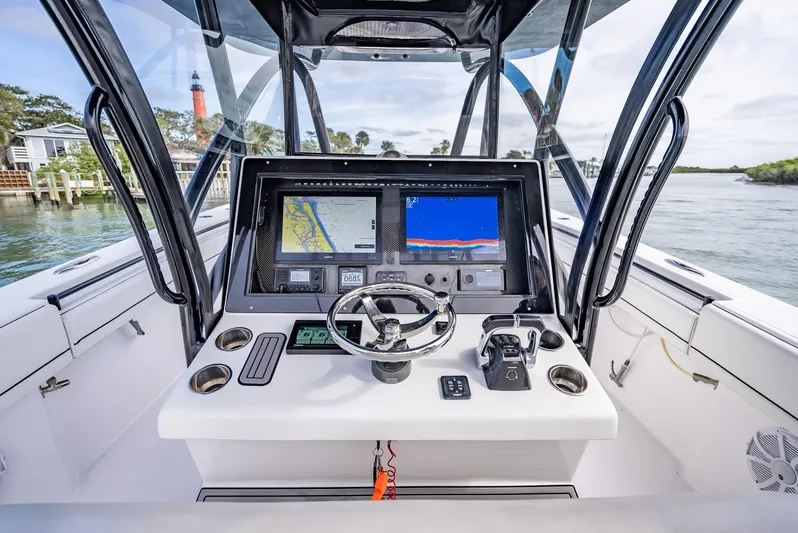  Yacht Photos Pics 2020 SeaHunter 35 Tournament boat dashboard with navigation screens and steering wheel.