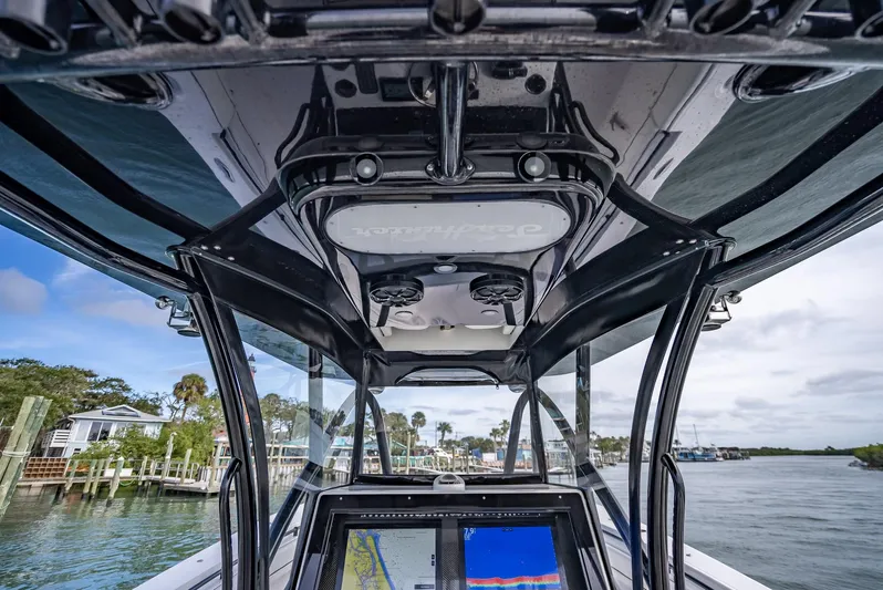  Yacht Photos Pics 2020 SeaHunter 35 Tournament boat console with navigation screens and overhead storage.
