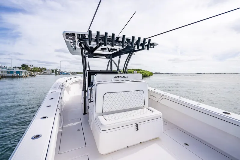  Yacht Photos Pics 2020 SeaHunter 35 Tournament boat with white seating and rod holders on a calm waterway.