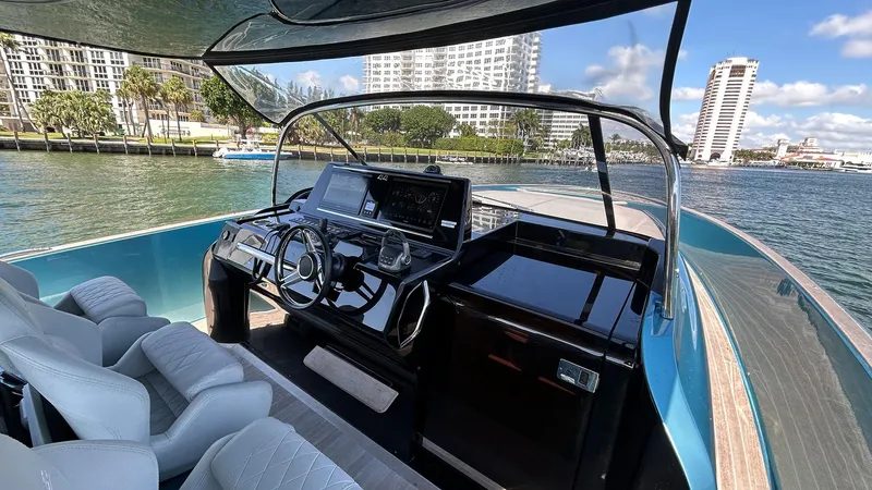  Yacht Photos Pics 2022 Solaris Power 44 yacht cockpit with modern controls, docked in a scenic waterfront location.