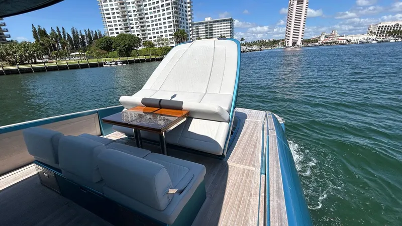  Yacht Photos Pics Luxurious 2022 Solaris Power 44 yacht with elegant seating, cruising near waterfront buildings.