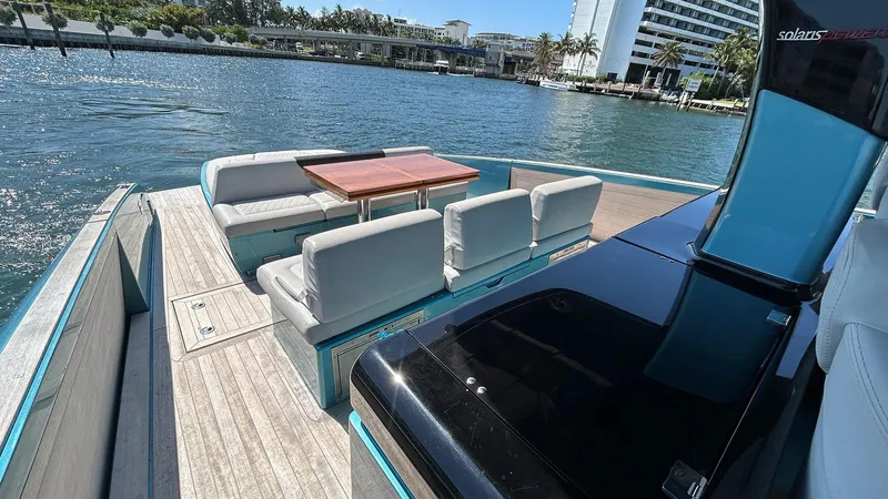  Yacht Photos Pics Luxurious 2022 Solaris Power 44 yacht with elegant seating and scenic waterfront view.