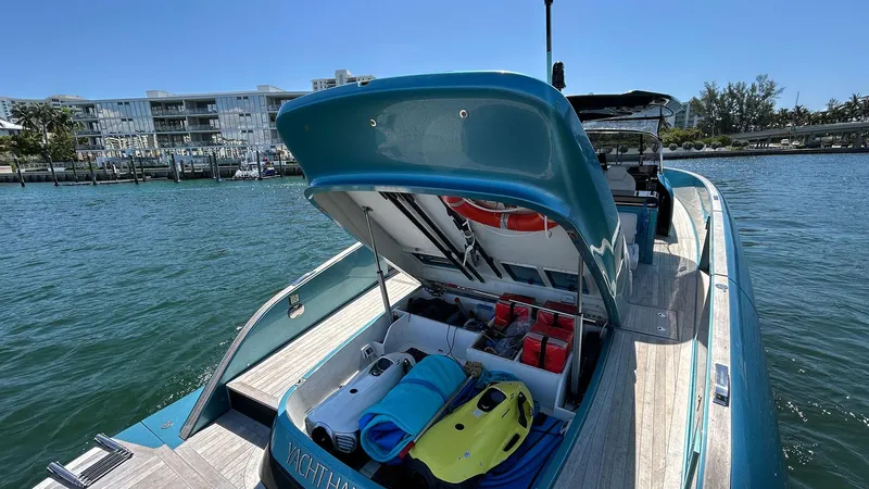  Yacht Photos Pics 2022 Solaris Power 44 yacht with open storage, docked by waterfront buildings.