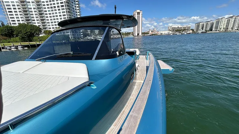  Yacht Photos Pics 2022 Solaris Power 44 yacht on water, city skyline in background.