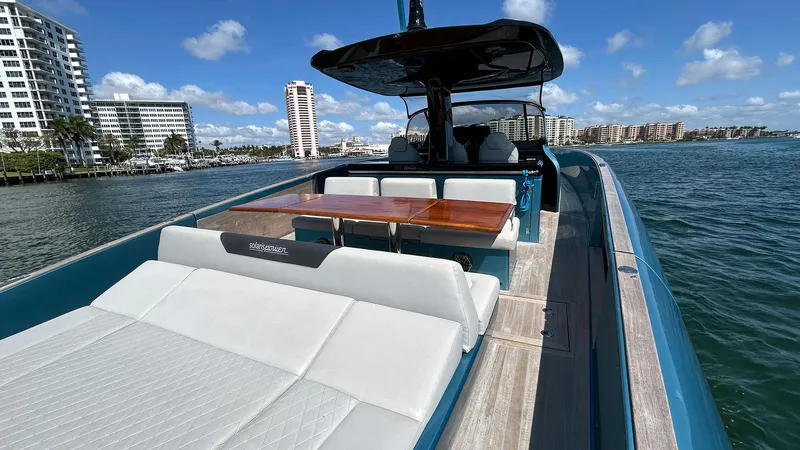  Yacht Photos Pics 2022 Solaris Power 44 yacht with spacious deck, luxurious seating, and scenic waterfront view.