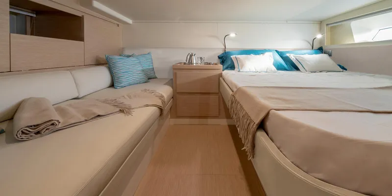  Yacht Photos Pics Luxurious interior of 2022 Solaris Power 44 yacht with cozy bed and seating area.