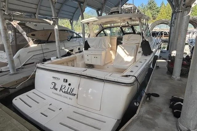 The Riddler Yacht Photos Pics 2009 Tiara Yachts 3600 Open docked, featuring spacious deck and covered seating area.