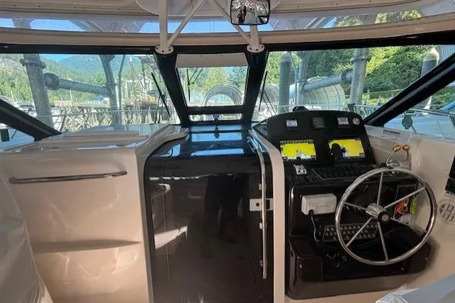 The Riddler Yacht Photos Pics 2009 Tiara Yachts 3600 Open helm with steering wheel and navigation displays.