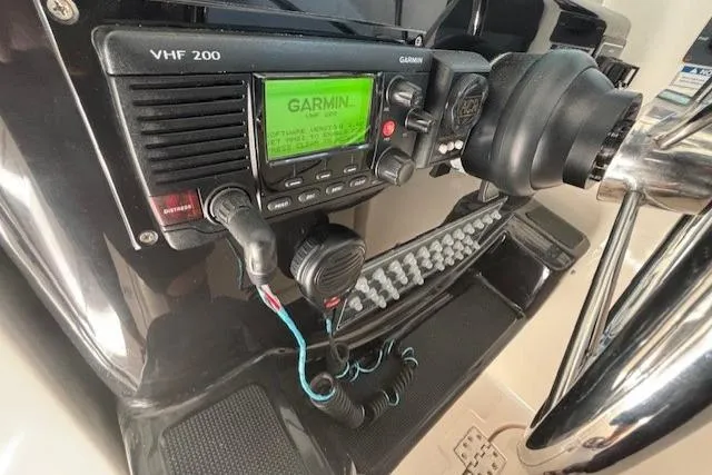 The Riddler Yacht Photos Pics 2009 Tiara Yachts 3600 Open helm with Garmin VHF 200 radio and steering wheel.