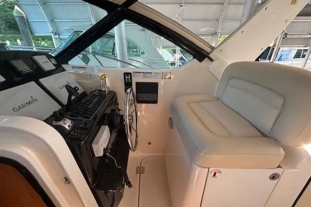 The Riddler Yacht Photos Pics 2009 Tiara Yachts 3600 Open helm with Garmin navigation and cushioned seating.