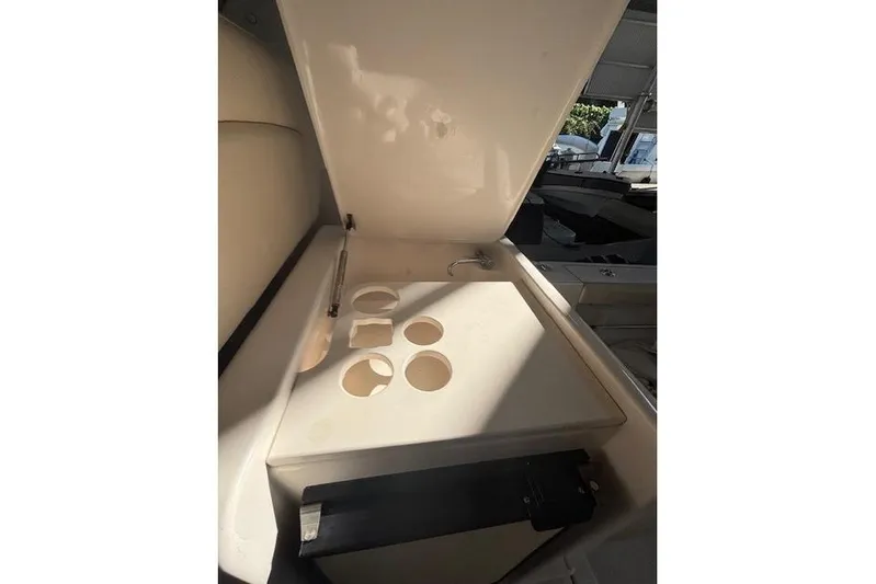 The Riddler Yacht Photos Pics 2009 Tiara Yachts 3600 Open interior with open storage compartment and cup holders.